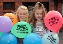Emma-Jayne and Victoria Gilmour pictured amid the 10th Anniversary balloons.